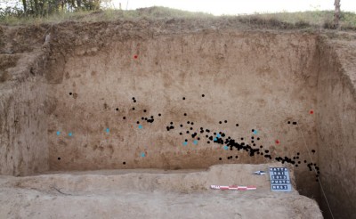 Figure 4. Longitudinal cross section of the Katta Sai site with location of artefacts. Black dots: stone artefacts; blue: mollusc shells; red: pottery. Photograph by Małgorzata Kot.